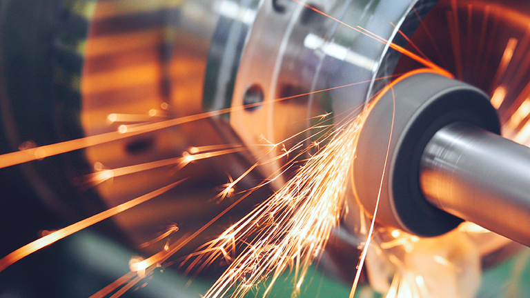 A closeup of a metal being grinded