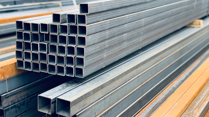 A closeup of steel cuboidal pipes in a warehouse