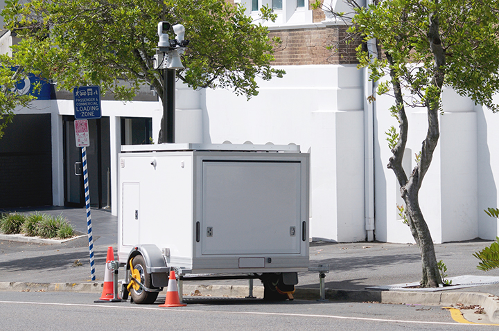 White security and communication mobile trailer parked on the roadside